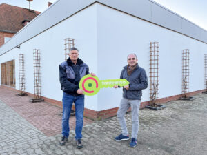 Enso-Expansionsmanager Steven Lüdeke (rechts) bei der Schlüsselübergabe an Vermieter Thorsten Schnelle. Foto: Tante Enso